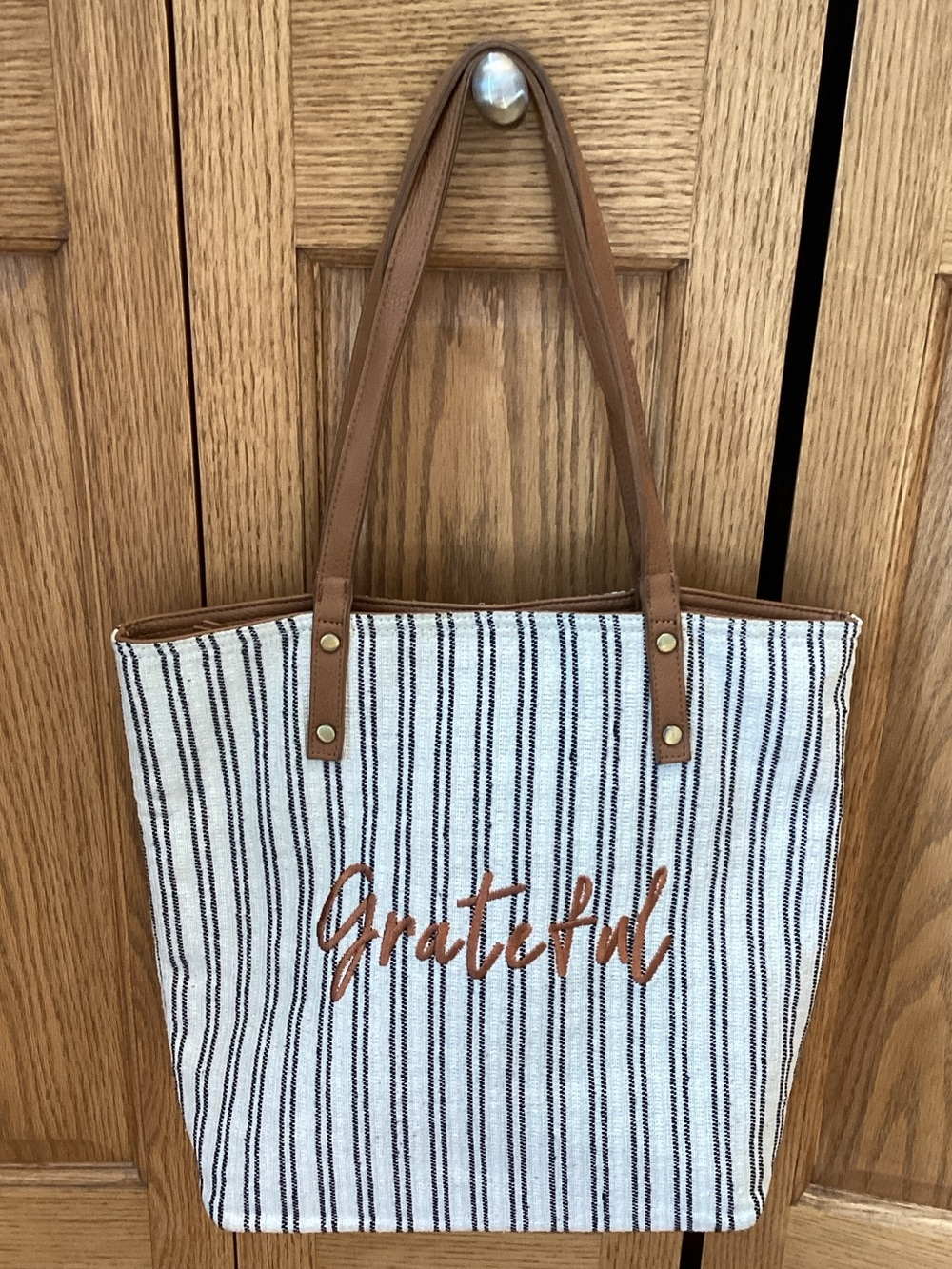 “Grateful” blue and white striped tote bag with tan straps